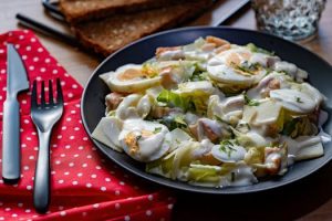 A delicious Caesar salad with chicken, egg, and creamy dressing.